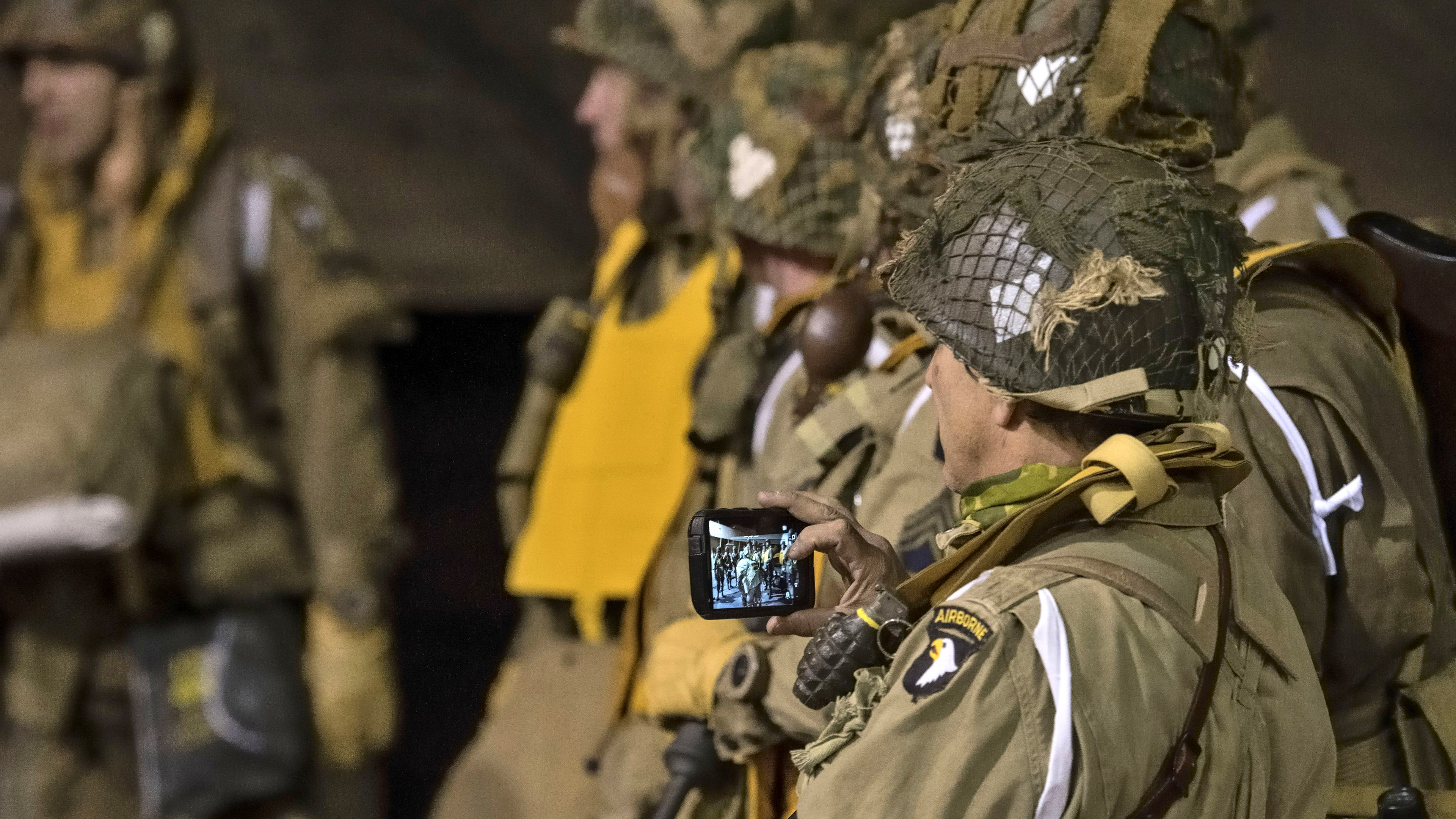 A member of the World War II Airborne Demonstration Team takes a photo before a dawn jump during a weeklong jump school. Many team members jumped from aircraft overflying Normandy, France, during the seventy-fifth anniversary of D-Day. Photo by Mike Collins.