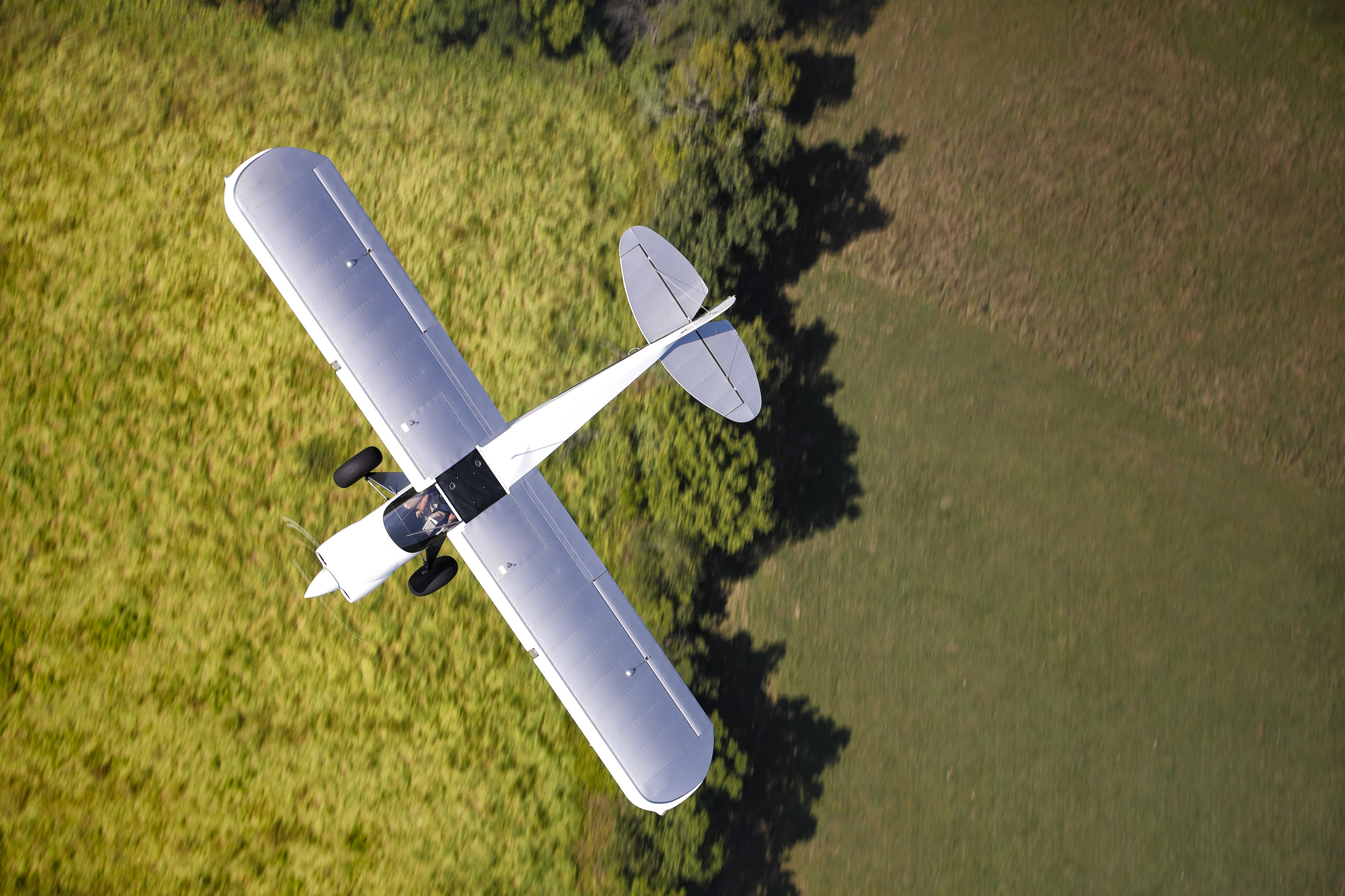 Toward the end of a midday summer shoot, the Carbon Cub FX-3 subject aircraft passed under the photo ship on the return leg to the airport. As I tracked it through the lens, I squeezed off one last frame—and it ended up as one of my favorites. Photo by Chris Rose.