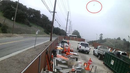 A security camera near Highway 101 and Moreau Road captured an image of the helicopter flying west along the highway (circled in red). Photo courtesy of the NTSB. 