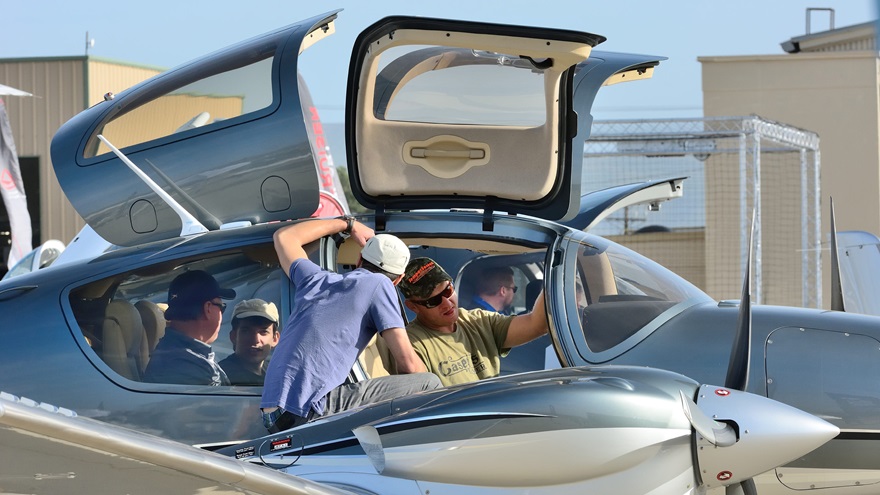 Attendees check out the cabin of a Diamond DA62 at AOPA's Camarillo Fly-In held in 2017. The DA62 is among several models of Diamond aircraft that use the Austro Engine E4 and E4P engines subject to a new airworthiness directive. Photo by Mike Collins.