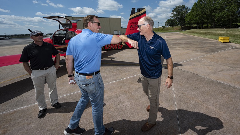 U.S. Rep. Ted Budd (R-N.C.), center, greets AOPA Air Safety Institute Executive Director Richard McSpadden after flying the Sweepstakes Van’s Aircraft RV-10 at AOPA headquarters in Frederick, Maryland, on July 28, 2020. Photo by David Tulis.