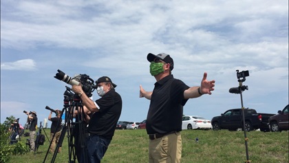 AOPA Editor in Chief Tom Haines spreads his arms out as the sound waves from the SpaceX Falcon 9 launch wash over him.