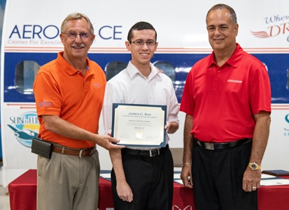 Isaac Castallanos was among the eight Central Florida Aerospace Academy graduates receiving financial awards for future aviation education. He is joined in the photo by Aerospace Center for Excellence President John "Lites" Leenhouts and Chairman of the Board Rick Garcia. Photo courtesy of Sun 'n Fun Aerospace Expo.