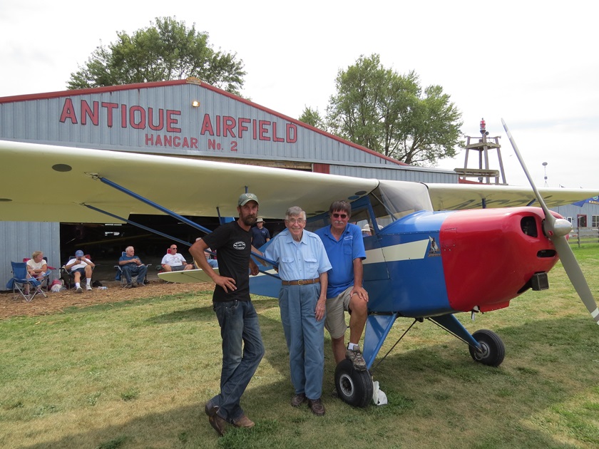 Antique Airplane Association founder Robert L. "Bob" Taylor joins son Brent, right, and grandson Ben, left, at Antique Airfield in Iowa. Photo courtesy of the Antique Airplane Association.