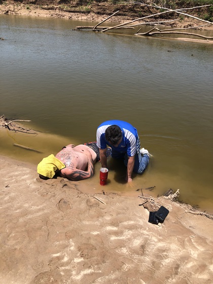 KFOR-TV photojournalist Steve Johnson comforts David Stokes after rescuing a man with helicopter pilot Mason Dunn. Photo courtesy of KFOR-TV.