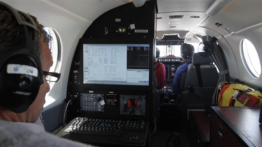 An FAA flight inspection crew validates instrument procedures in 2012, flying a King Air equipped with an array of antennas and specialized equipment to confirm the accuracy, functionality, and safety of procedures and navigation aids. Photo by Jim Moore.