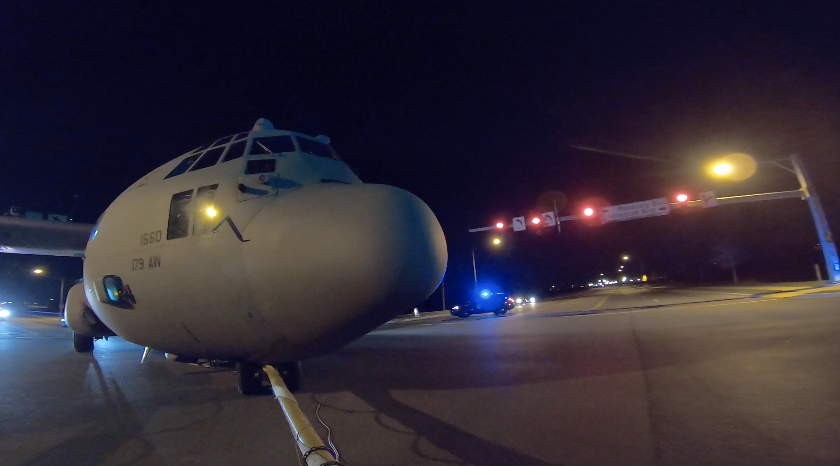 Police halt early morning traffic to move a retired 1974 U.S. Air Force Lockheed C-130H Hercules military aircraft from Frederick Municipal Airport to Fort Detrick. More than 20 local and state law enforcement personnel participated in the overnight move. Photo by David Tulis.