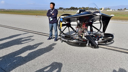 Akihiro Mizutani, a member of Team teTra, takes his turn posing with the team from Japan's aerial vehicle at the GoFly Prize Final Fly Off. The team had just received Pratt & Whitney's $100,000 Disruptor award. Photo by Mike Collins.