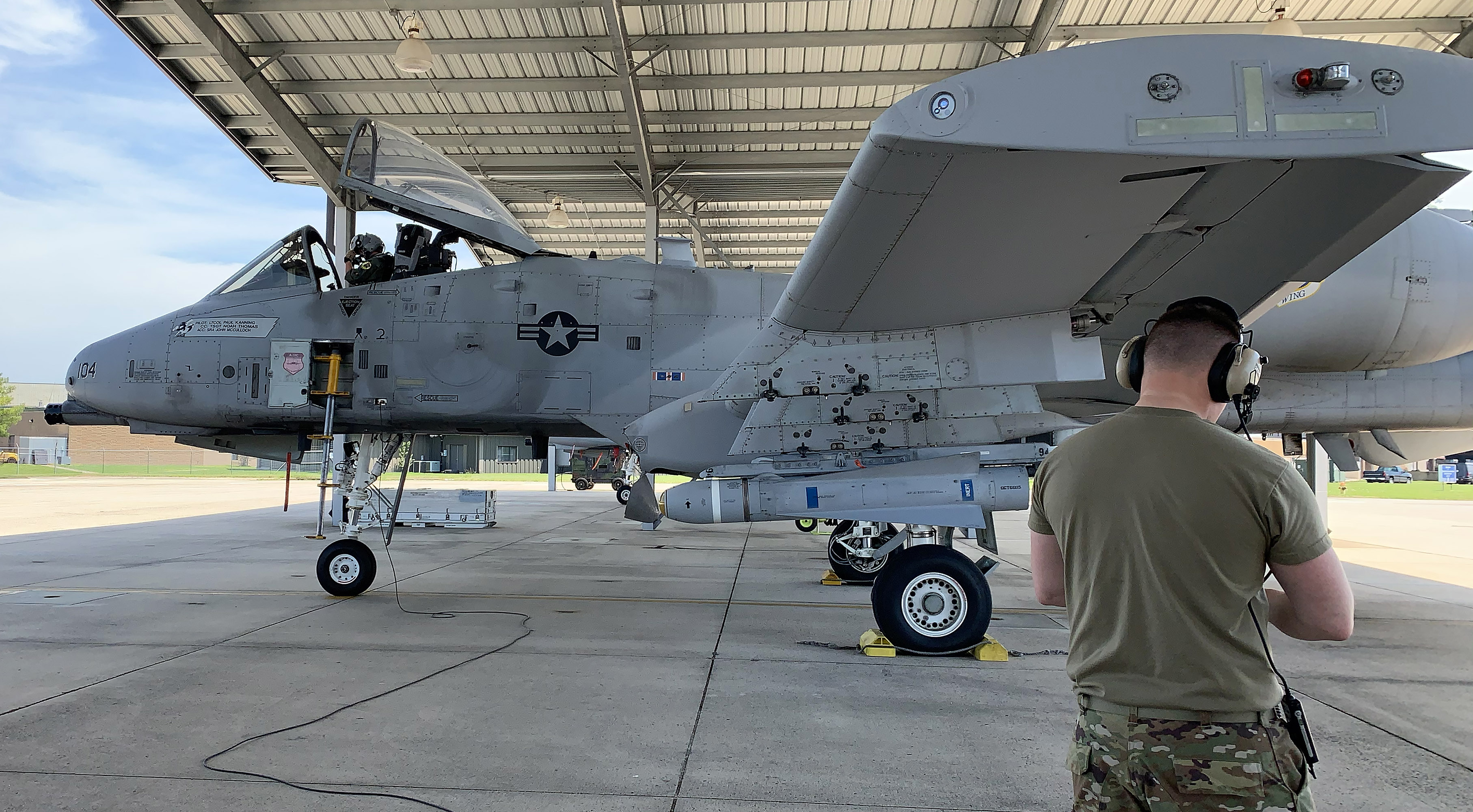 Maryland Air National Guard Airman 1st Class Andrew Boenig helps 1st Lt. Taylor "Pistol" Price before a training mission in a Fairchild Republic A–10C Thunderbolt II jet. Photo by Erick Webb.