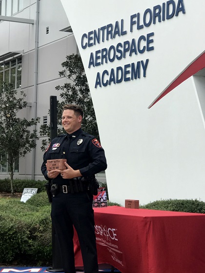 Cory Suttle, a school resource officer at Central Florida Aerospace Academy, was honored for earning his private pilot certificate alongside the school's students as part of an annual celebration. Photo by Jamie Beckett.