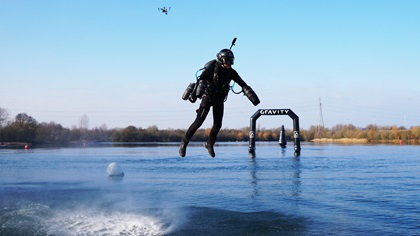 Richard Browning navigates a jet suit racecourse set up over water. Photo courtesy of Gravity Industries.