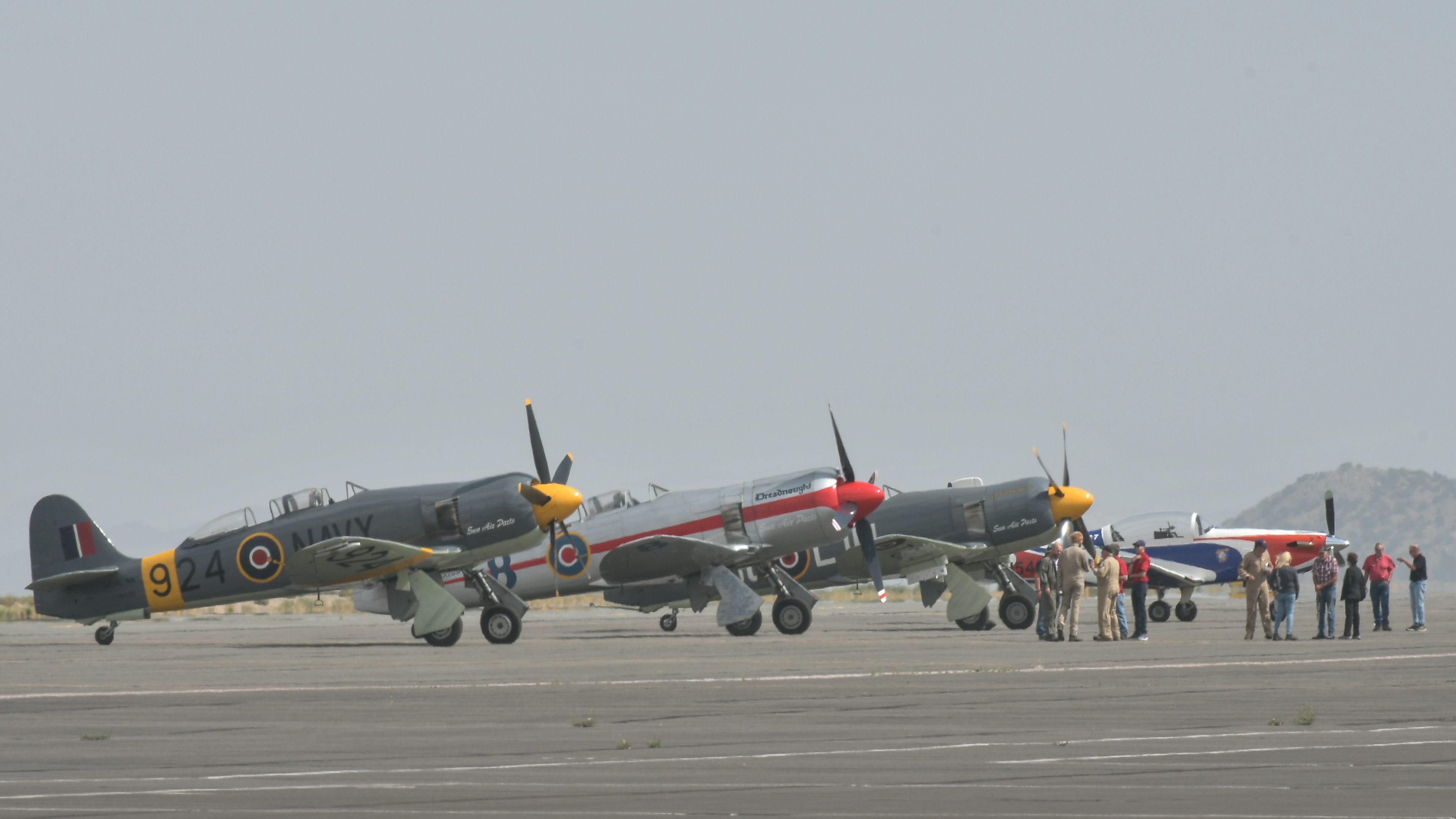 Smoky haze from California wildfires is evident as some pilots with the Reno Air Races gather on the ramp at Reno/Stead Airport on what would have been the 2020 race weekend. Photo by Joanne Murray.