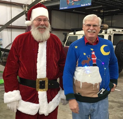 Santa, who flew a red, white, and blue Van's RV-7A, stands with Ed Nabb Jr. in a hangar at Bay Bridge Airport prior to departing for Tangier Island. Nabb's father founded the Holly Run in 1968. Photo by Joe Kildea.