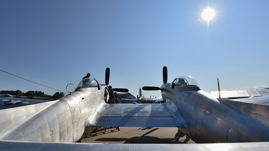 Members of Tom Reilly's crew button up the left cowl of his prototype North American XP-82 Twin Mustang at EAA AirVenture Oshkosh 2019. They had been troubleshooting a minor cooling issue. Photo by Mike Collins.