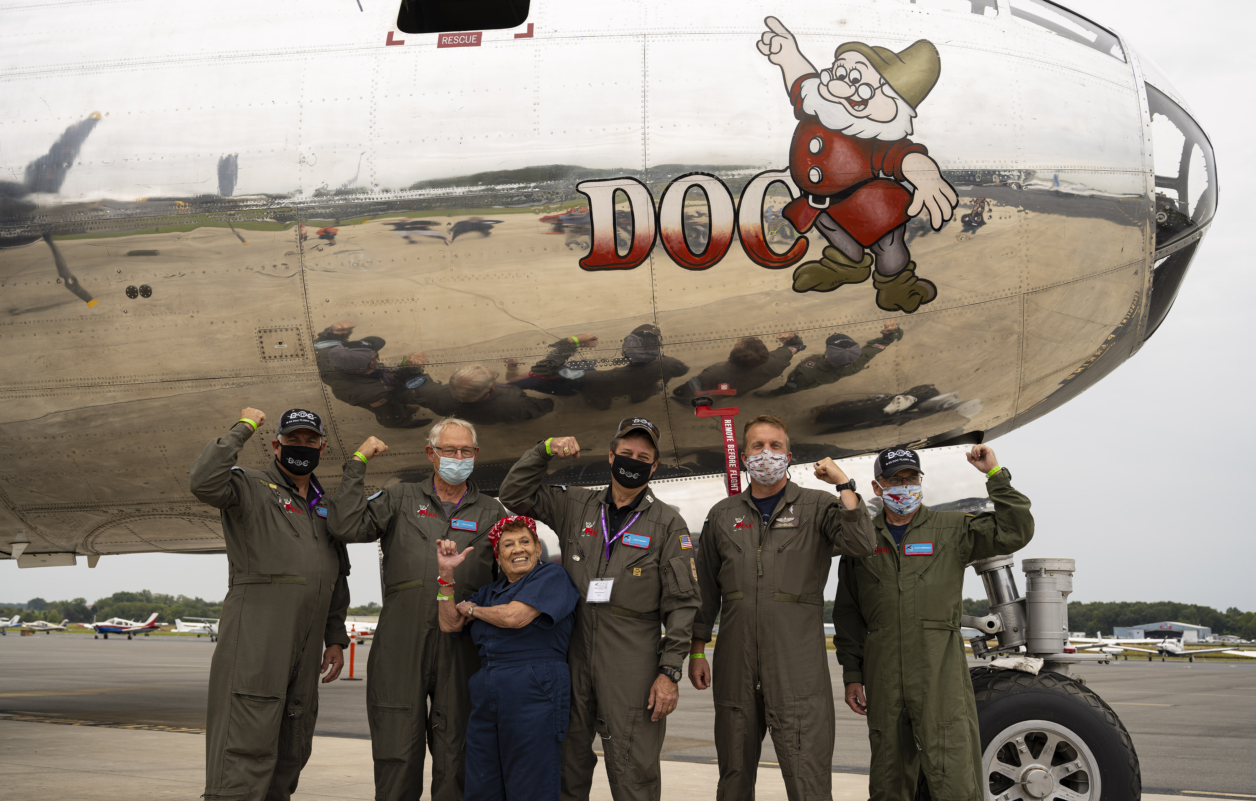 One of the original ‘Rosie the Riveters,’ Connie Palaciozas, joins crew members for the Boeing B-29 Superfortress ‘Doc,’ which she helped construct during World War II. AOPA Photo by David Tulis.