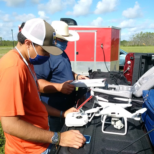 Andrés Larrota and John Robbins conduct final checks before launching a DJI Phantom 4 Pro. (Photo by Marc Compere, courtesy of Embry-Riddle Aeronautical University.)