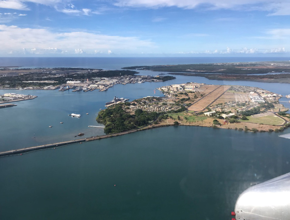 The warbird aerial parade flies by the "USS Arizona" Memorial. Photo courtesy of KT Budde-Jones.
