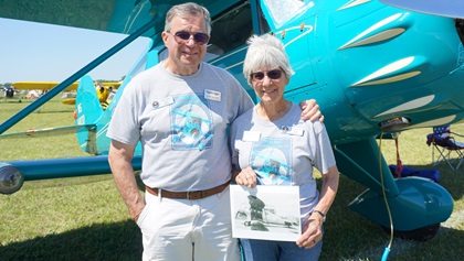 Dave and Jeanne Allen, of Elbert, Colorado, hold an original picture of their 1934 Waco YKC aircraft. Photo by Cayla McLeod.