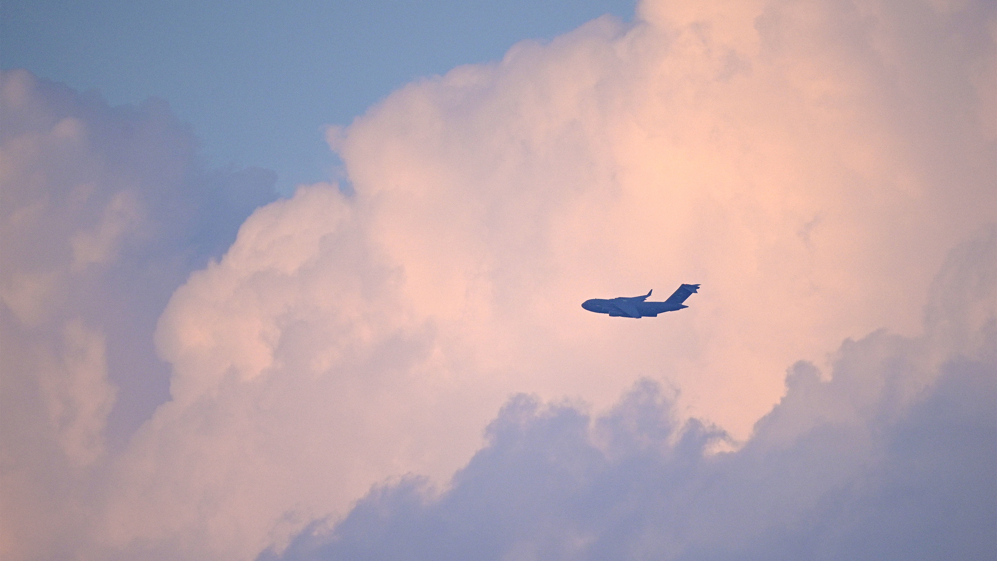 An aircraft flies into the sunset during the night airshow at the Sun 'n Fun Aerospace Expo on April 14. Photo by Phelan M. Ebenhack.