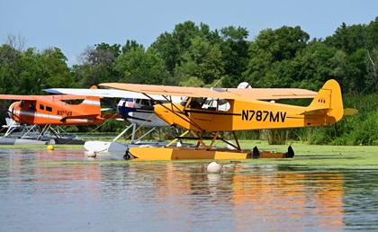 Seaplanes are moored in a cove at the EAA Seaplane Base on Lake Winnebago during EAA AirVenture in Oshkosh, Wisconsin. Photo by David Tulis.