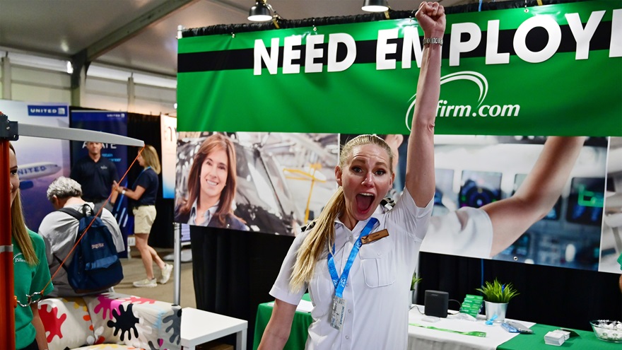 Ravn Alaska First Officer Crystal Frost reacts after winning a "hook 'em" game at the JSfirm jobs booth in the EAA AirVenture Careers and Education Center. Frost said traffic was about 50 percent higher in 2021 than in 2019. Photo by David Tulis.