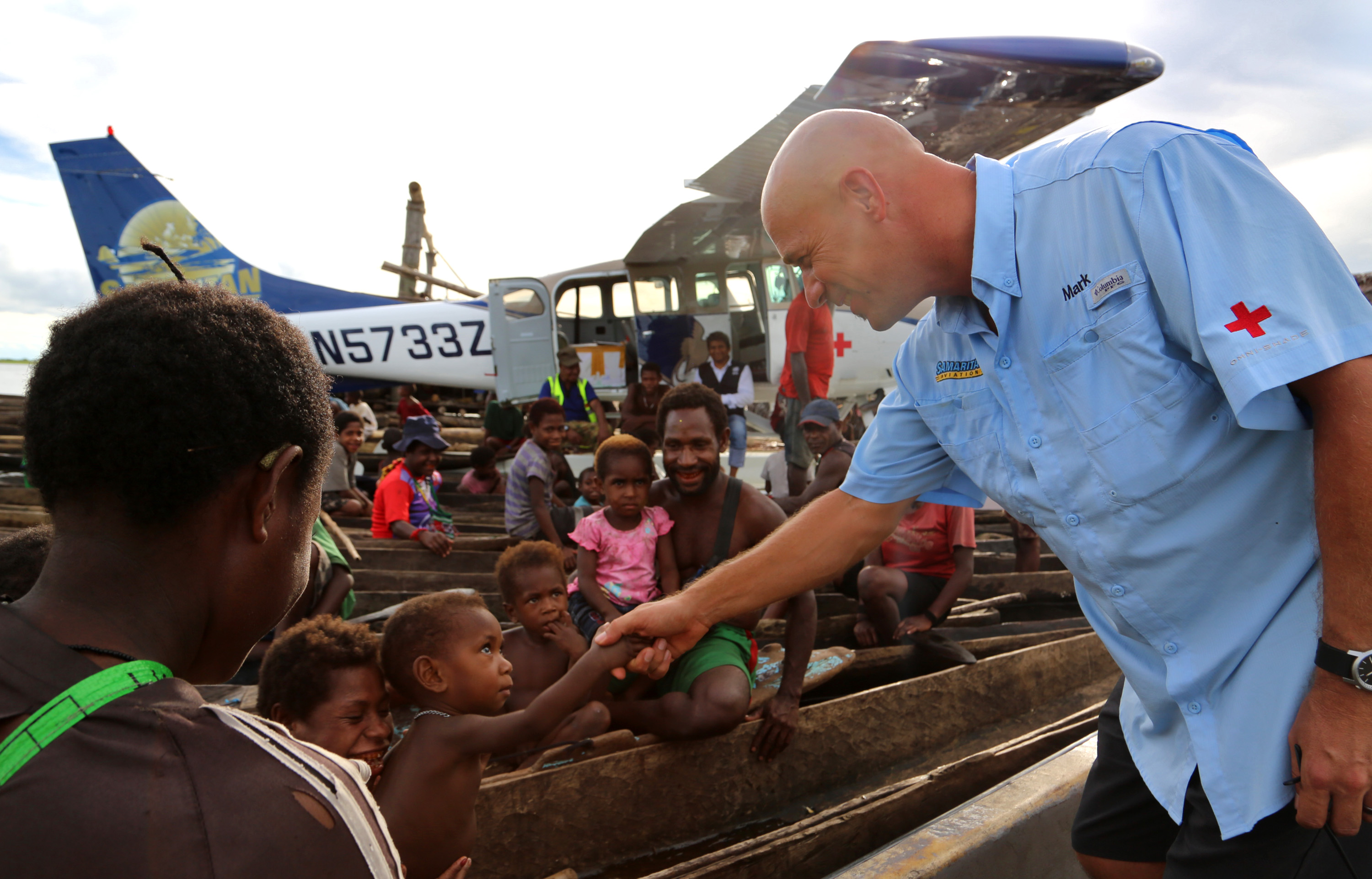 Samaritan Aviation founder Mark Palm visits with villagers greeting him from canoes along the Sepik River in Papua New Guinea. Photo courtesy of Samaritan Aviation.