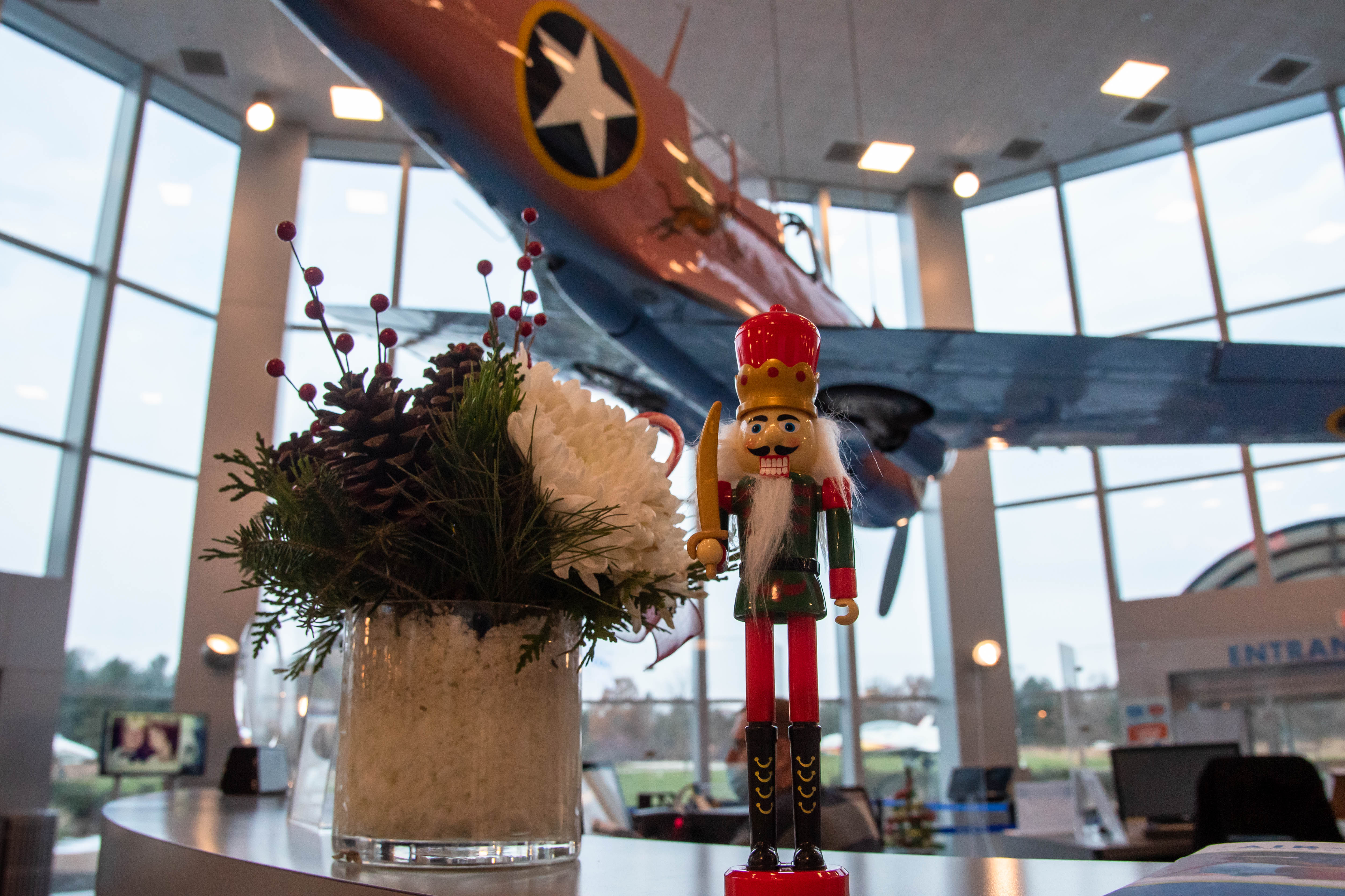 A festive nutcracker stands guard before a Curtiss P–40 Warhawk  in the Air Zoo’s festive lobby. Photo courtesy of The Air Zoo.