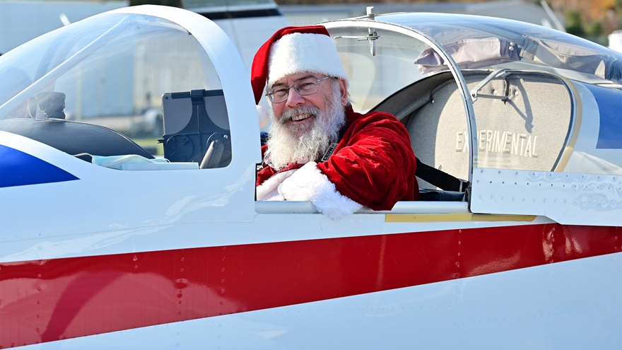 Santa Claus and general aviation pilot Ralph Hoover leads more than 40 aviators to Tangier Island, Virginia, in the Chesapeake Bay to deliver holly branches, school supplies, and holiday presents during the annual Holly Run charity fly-out Saturday, December 4. The event was canceled in 2020 because of the coronavirus pandemic. Photo by David Tulis.