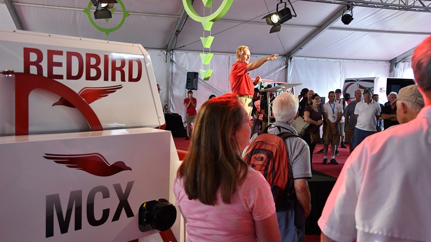 Redbird founder Jerry Gregoire explains the flight simulator company's GIFT curriculum that challenges students with certain simulated flight maneuvers. Photo by David Tulis.