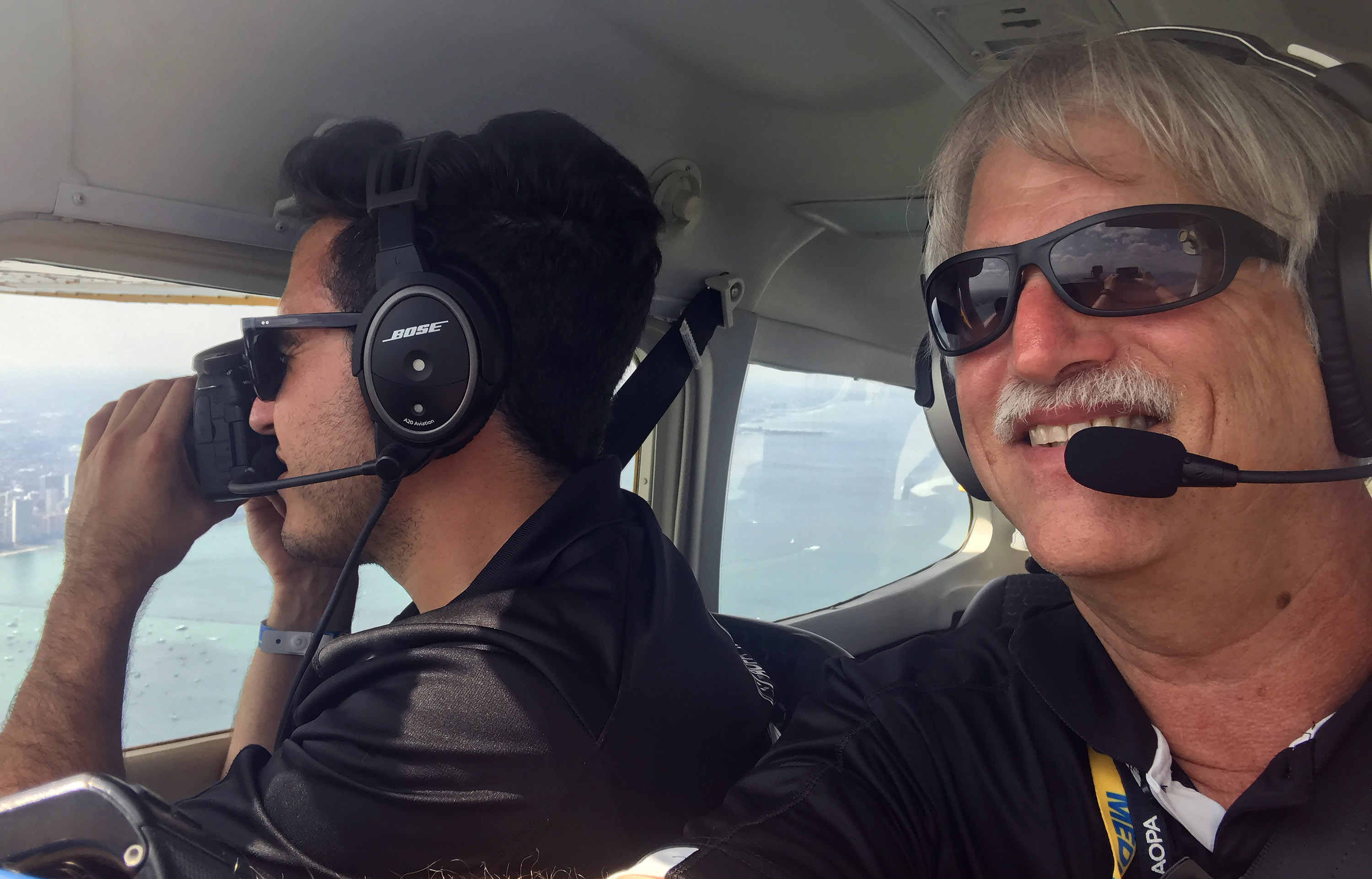 The author and AOPA Social Media Marketer Kevin Cortes fly near the Chicago skyline before landing at Burke Lakefront Airport in Cleveland, Ohio, and checking in with the AOPA app's Pilot Passport feature. Photo by David Tulis.