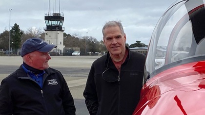AOPA President Mark Baker surprises Aaron Benedetti with the AOPA Sweepstakes RV-10. Photo by Chris Rose.