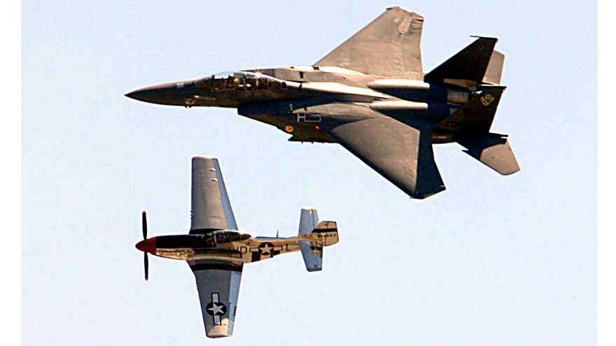 Capt. Phil Smith, 4th Operations Group F-15E Strike Eagle demonstration team, flies in close formation with a P-51 Mustang, flown by retired Capt. Dale Snodgrass, during the Wings Over Wayne Air Show at Seymour Johnson Air Force Base, North Carolina, on April 26, 2009. Snodgrass was killed in a single-engine backcountry aircraft during takeoff from an Idaho airport on July 24. U.S. Air Force Photo by 2nd Lt. Matthew D. Schroff.