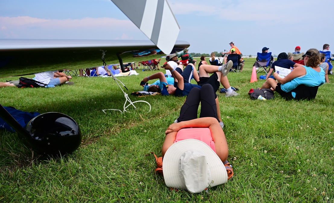 Spectators relax during the opening day’s afternoon airshow at EAA AirVenture. Photo by David Tulis.