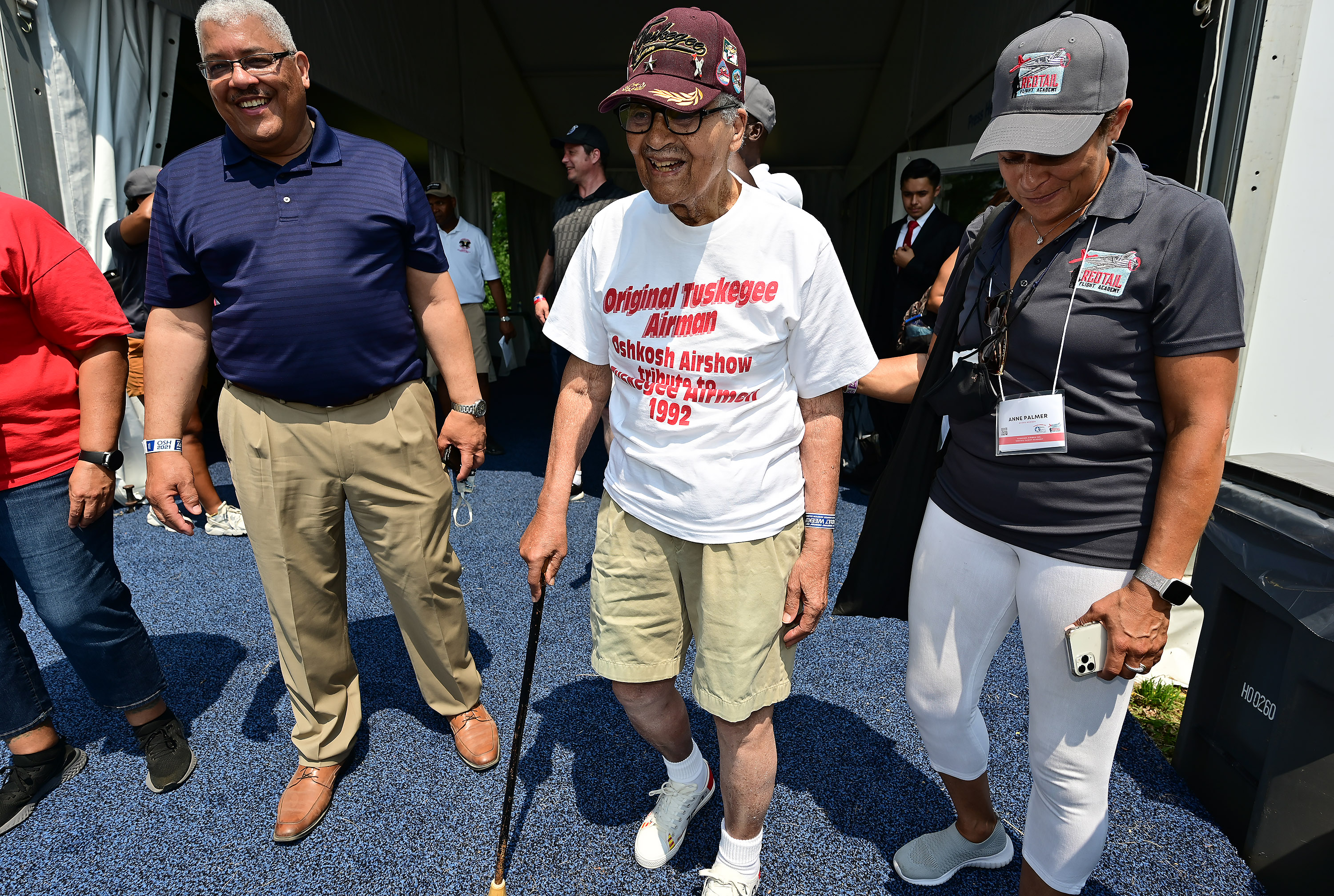 Brig. Gen. Charles McGee, 101, is escorted from a Tuskegee Airmen Redtail Flight Academy news conference during EAA AirVenture in Oshkosh, Wisconsin, Monday, July 26. McGee served in the US Air Force during three wars and is on site at the Rise Above exhibit to sign autographs and pose for photos. Photo by David Tulis.