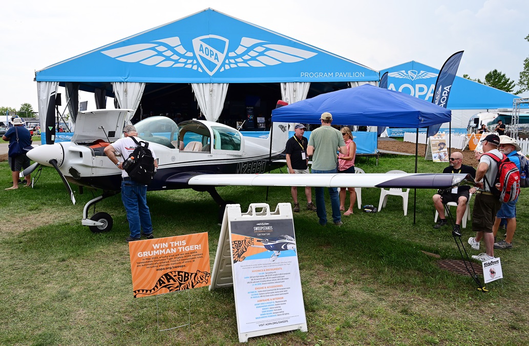 EAA AirVenture attendees gather around the AOPA Sweepstakes Grumman Tiger. Photo by David Tulis.