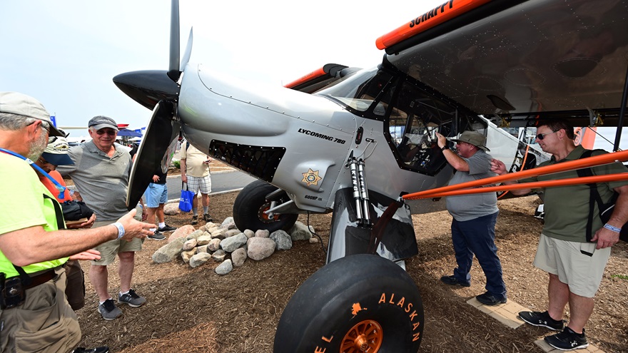 The STOL aircraft 'Scrappy' designed and built by Mike Patey draws a crowd in front of the Garmin display during EAA AirVenture July 28. Photo by David Tulis.