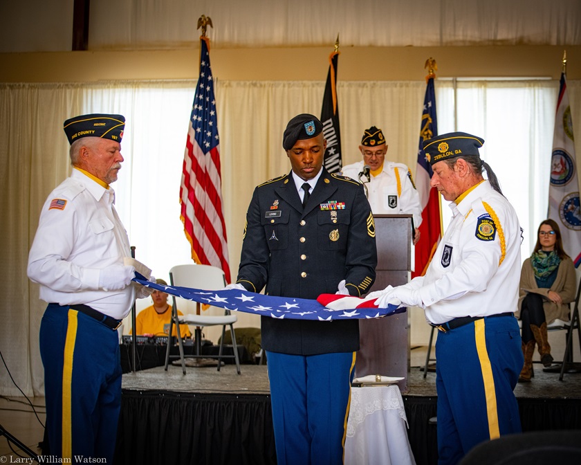 Members of the Pike County American Legion fold the American flag as part of Peach State Aerodrome’s Veterans Day ceremony and fly-in. Photo by Larry William Watson.