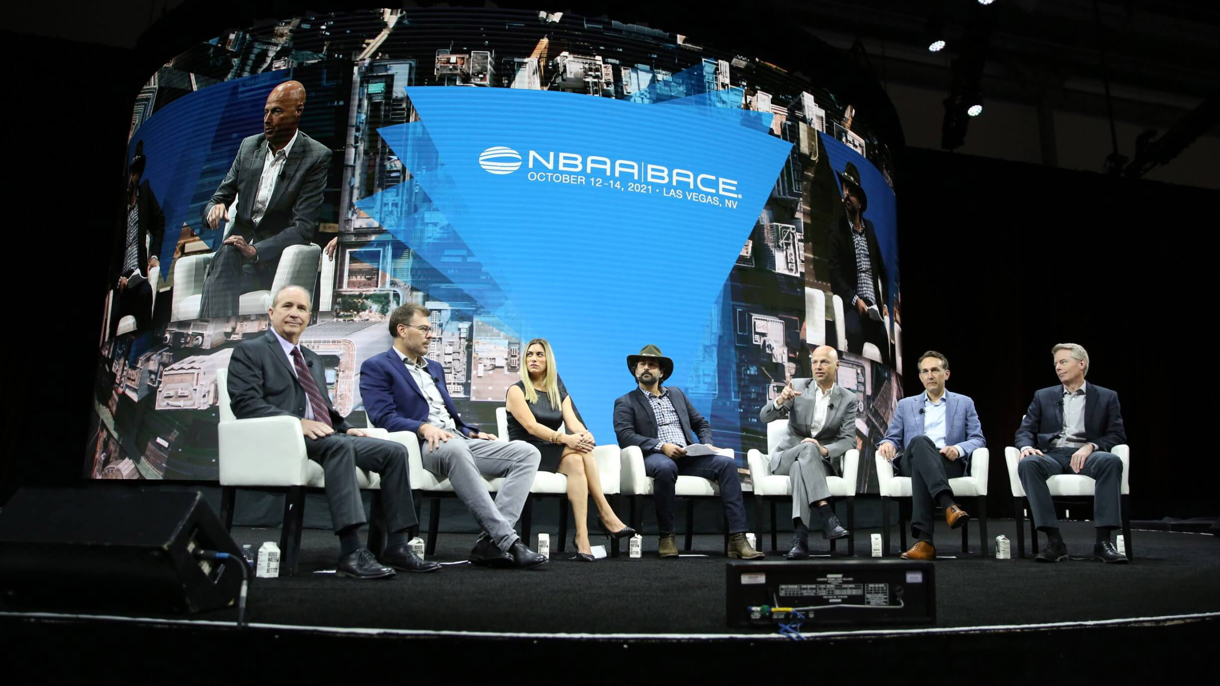 As part of the October 13 keynote session at the National Business Aviation Association’s convention in Las Vegas, a panel  discuss the future of advanced air mobility (left to right):  Jaunt Air Mobility CEO Martin Peryea, Beta Technologies CEO Kyle Clark, Blade Urban Air Mobility President Melissa Tomkiel, jetAVIVA Executive Chairman  and UP .Partners Managing Partner Cyrus Sigari, Kitty Hawk Corp. CEO Sebastian Thrun,  Joby Aviation Head of Product Eric Allison, and Overair CEO Ben  Tigner. Photo courtesy of NBAA. 