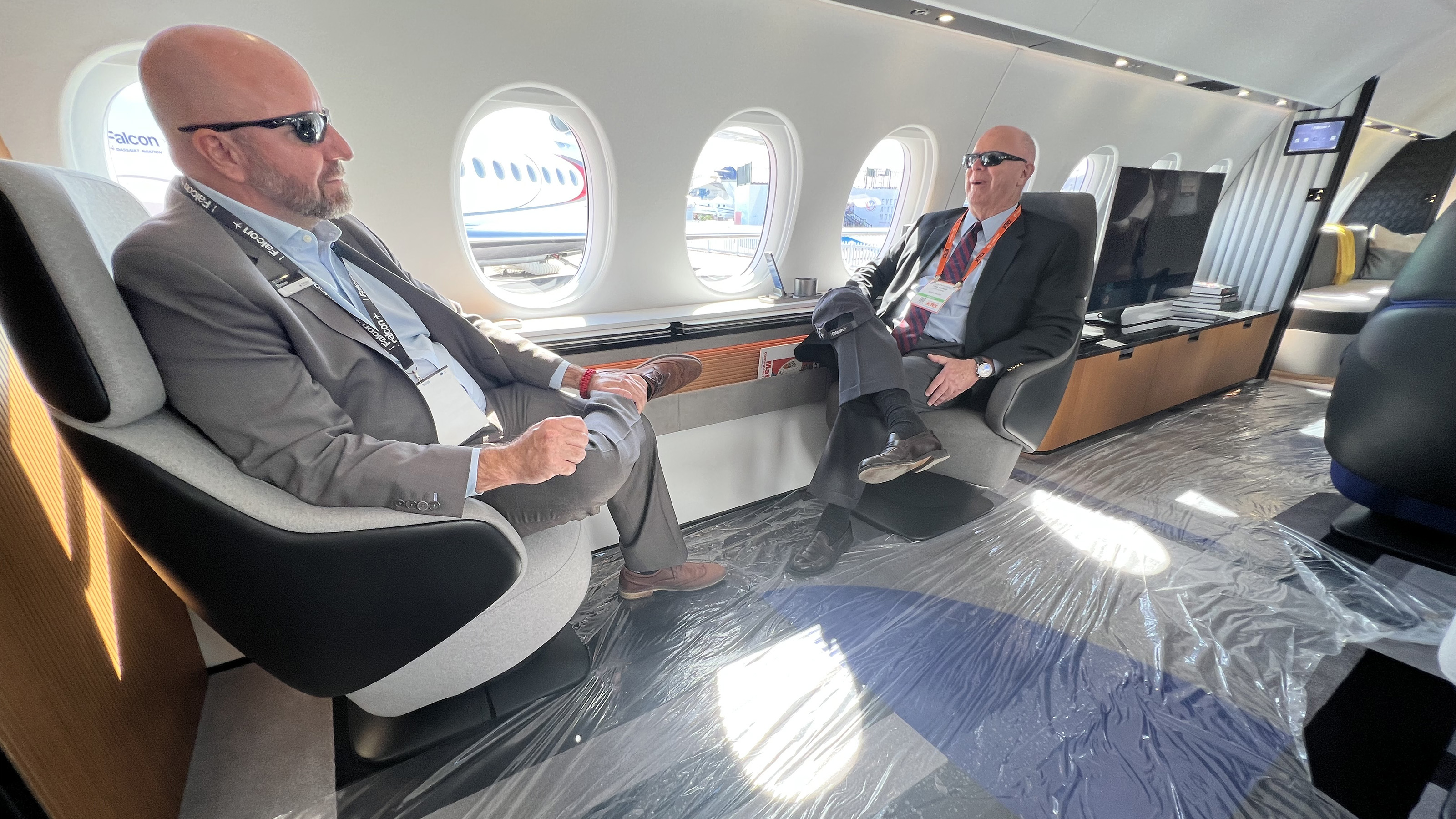 Andrew Ponzoni, media relations director for Dassault Falcon Jet, left, chats with AOPA Editor at Large Tom Horne aboard the mockup of the forthcoming Falcon 10X. Photo by Paul Harrop. 