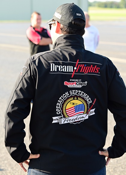 Dream Flights pilot Max Combeau wears an Operation September Freedom jacket that reflects the mission intended to honor more than 1,000 World War II veterans with open-cockpit biplane flights from August 1 through September 30. Photo by David Tulis.