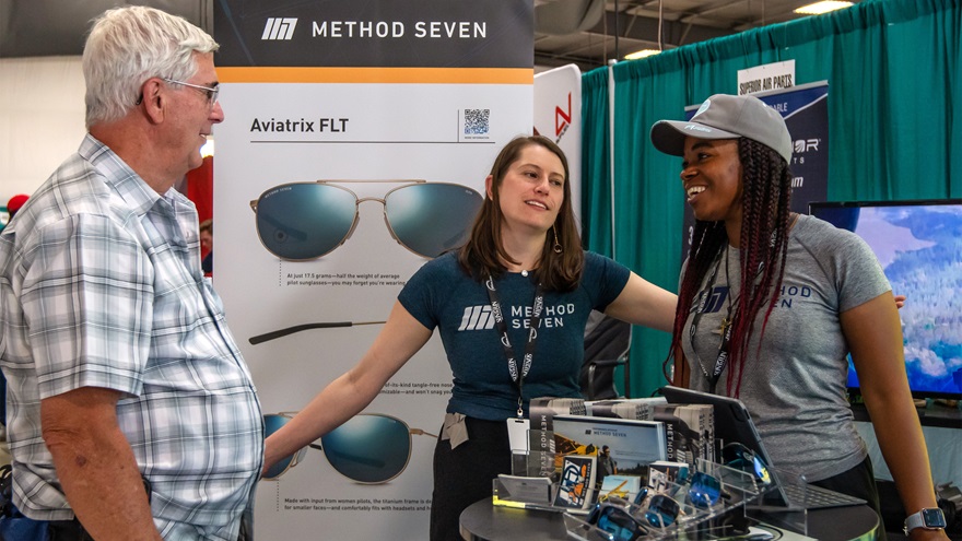 Members of the Method Seven crew speak with a customer in the Sun 'n Fun exhibitor hall. Photo by Niki Britton.