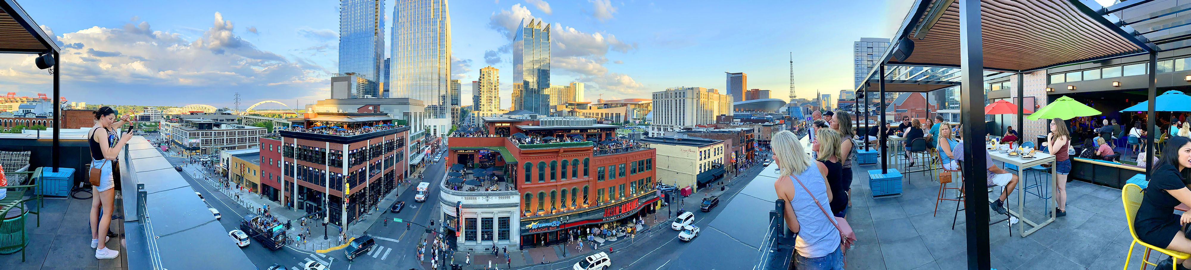 The setting sun illuminates rooftop bars along Broadway’s ‘Music Row’ in downtown Nashville. Photo by David Tulis.