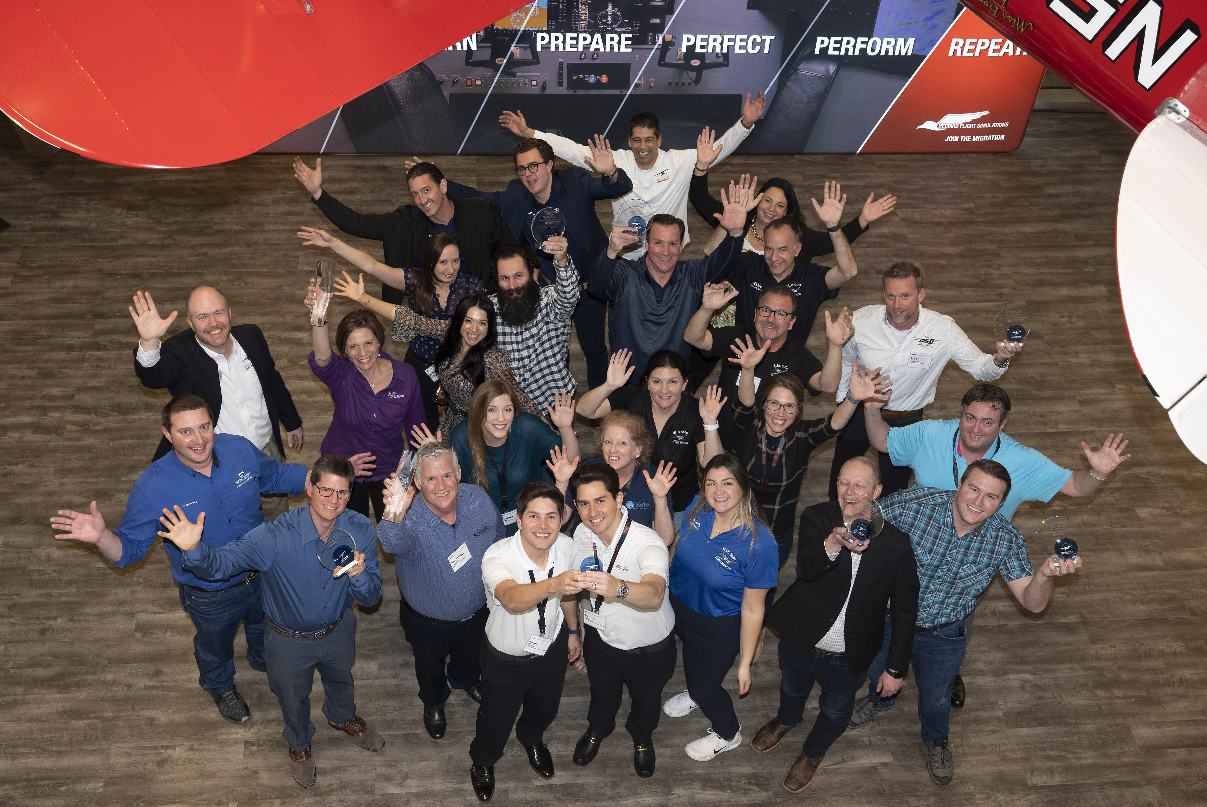 AOPA Flight Training Experience Awards winners celebrate after a ceremony at the Aerospace Center for Excellence. Photo by David Tulis.