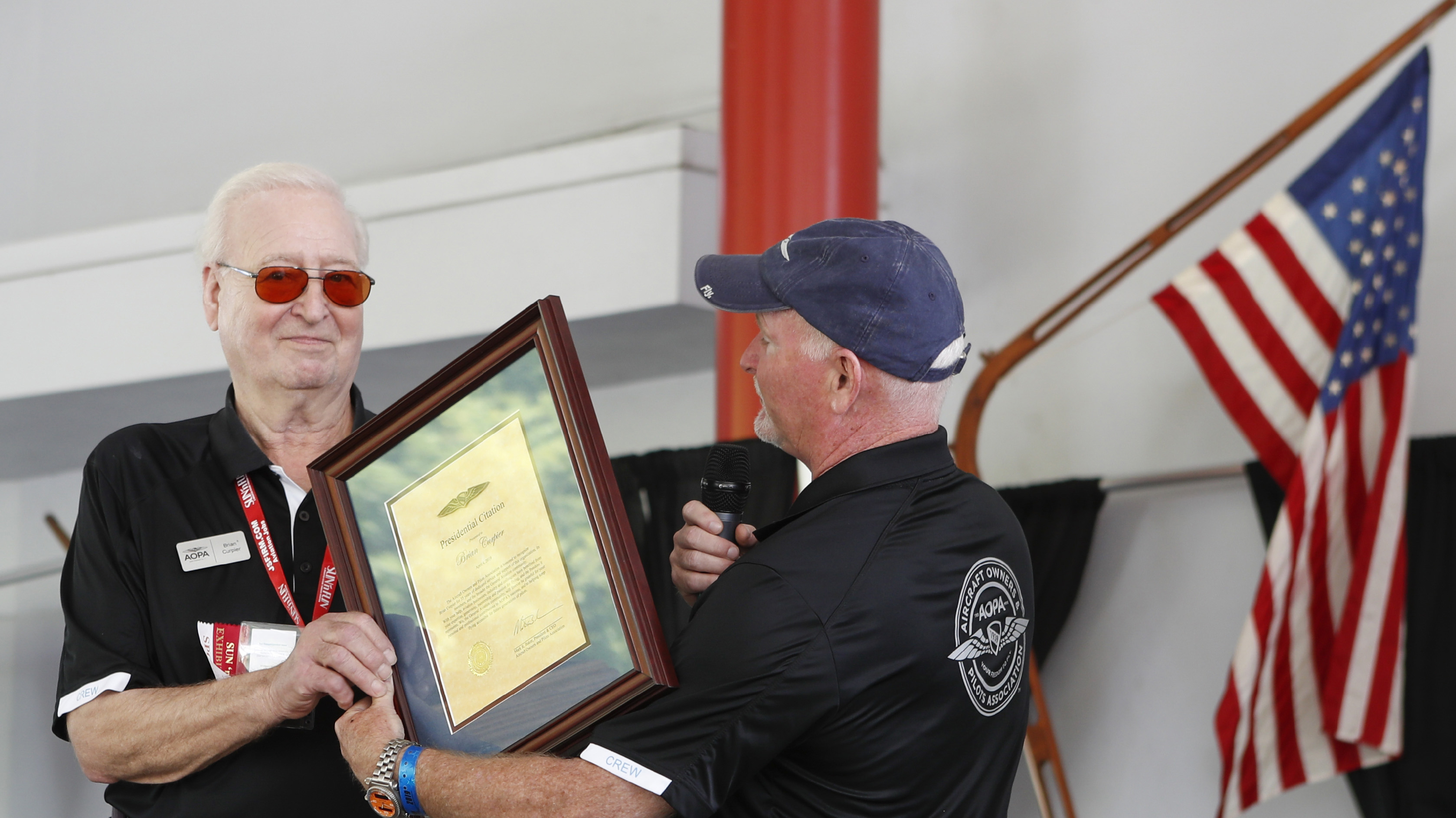 AOPA President Mark Baker presented Brian Curpier with a citation in April 2019 honoring Curpier's more than 35 years working for AOPA. Curpier died February 12. Photo by Chris Rose.