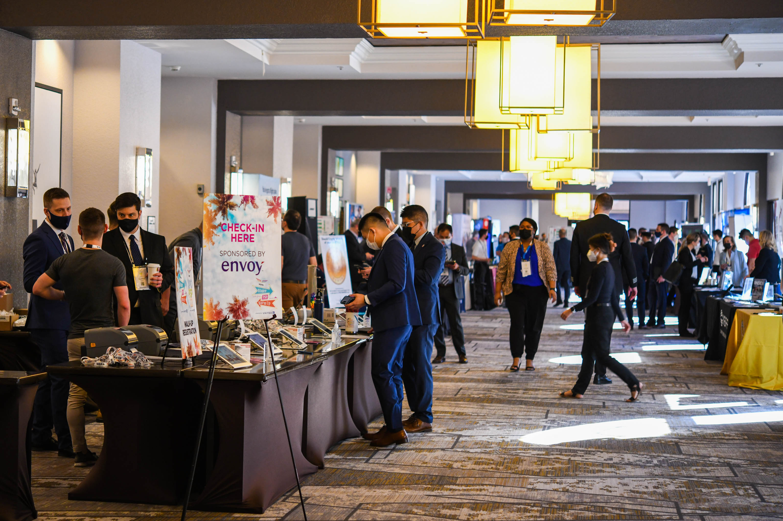 NGPA Industry Expo attendees check in at the registration desk and visit exhibitors in the main hallway. Photo by Niki Britton.