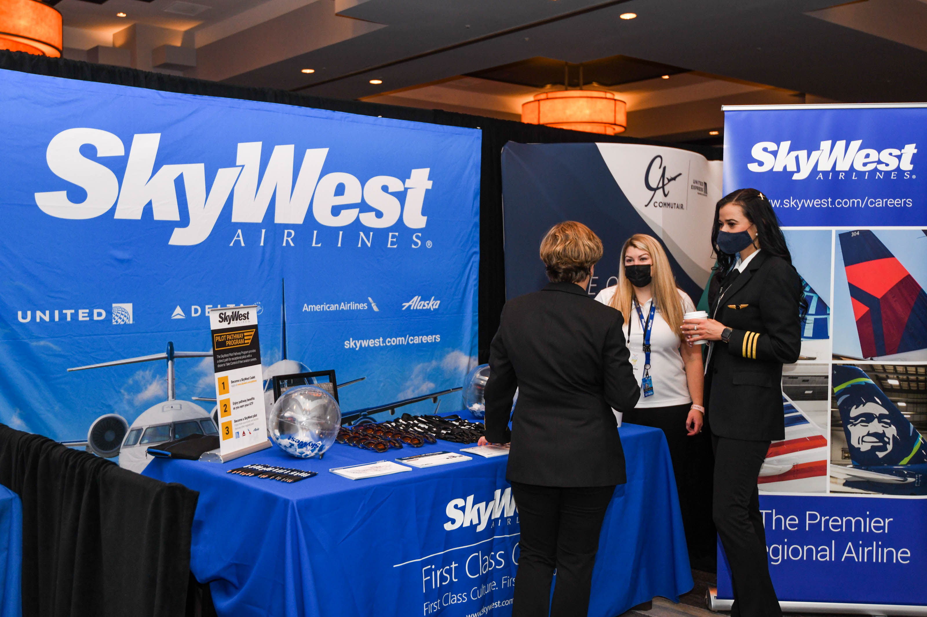 SkyWest Airlines representatives and first officer chat at their booth at the NGPA industry Expo. Photo by Niki Britton.