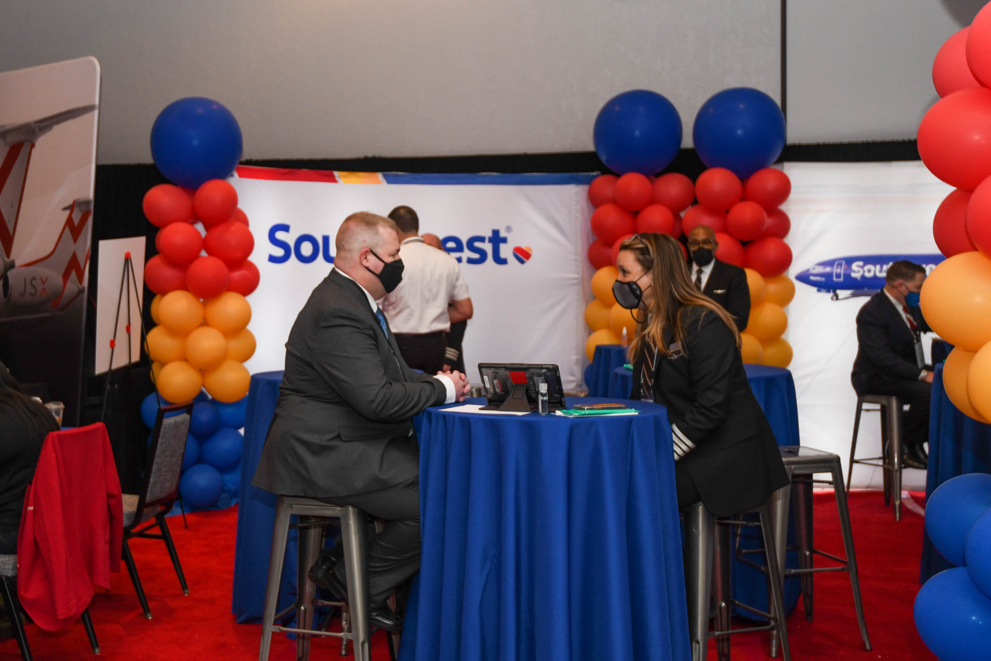 A job seeker meets with a Southwest Airlines captain for a one-on-one at the Southwest booth at the NGPA Industry Expo. Photo by Niki Britton.