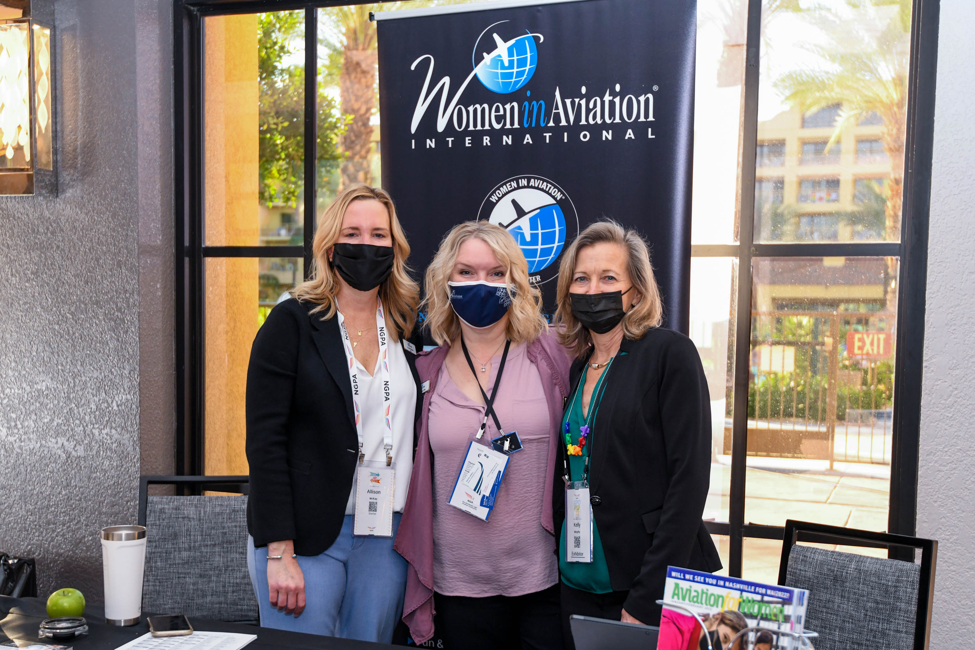 Women in Aviation International CEO Allison McCay, Director of Communications Kelly Murphy, and Director of Conferences and Events Kerisa Citro pose for the camera at their NGPA Industry Expo booth. Photo by Niki Britton.