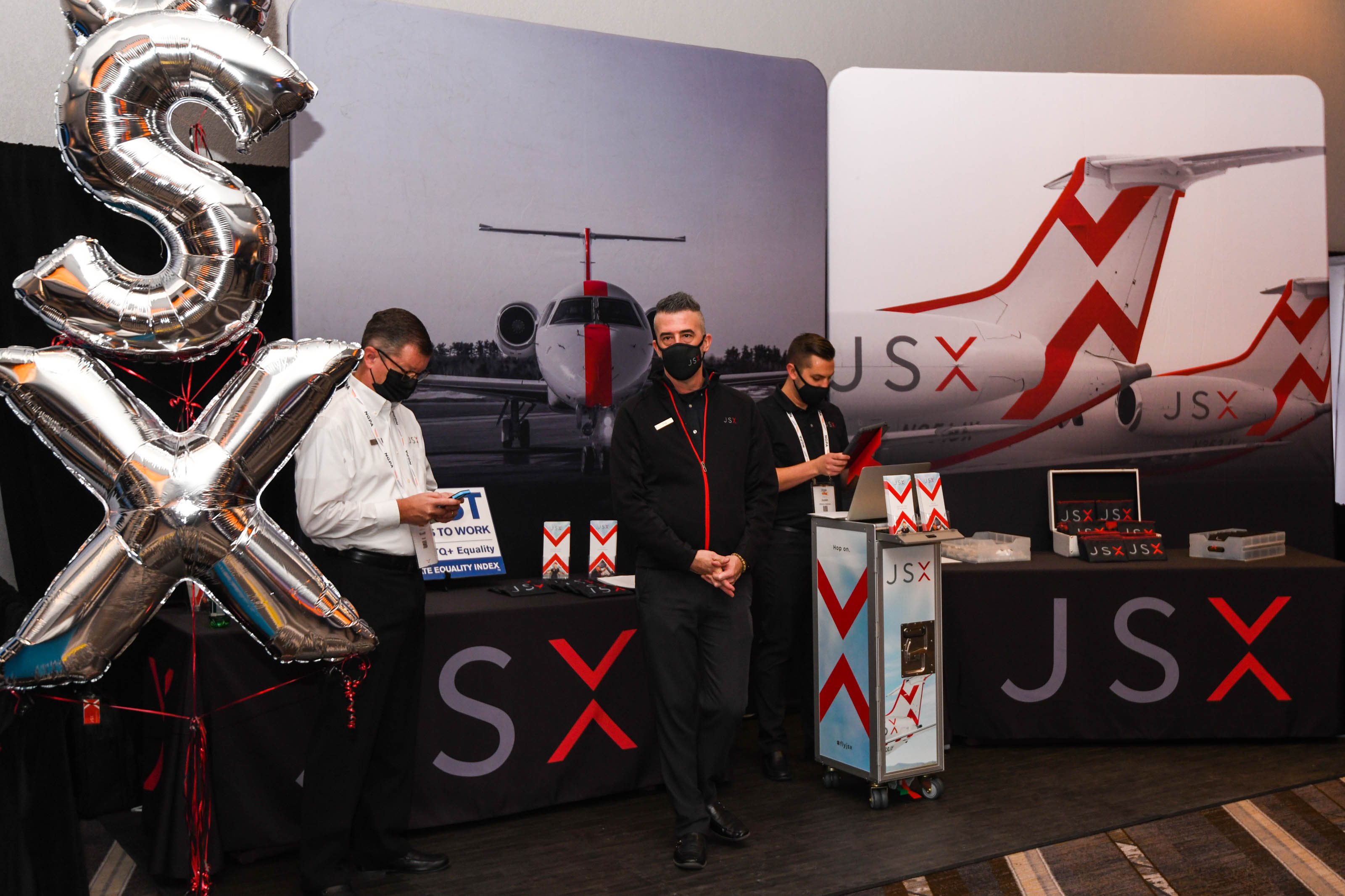 Representatives from JSX await attendees in the NGPA Industry Expo main hall. Photo by Niki Britton.