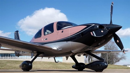 The all-new, fully loaded, and somewhat pink Cirrus SR22T parked in front of AOPA headquarters, tempting the staff to take a short walk for a closer peek. Photo by Josh Cochran. 